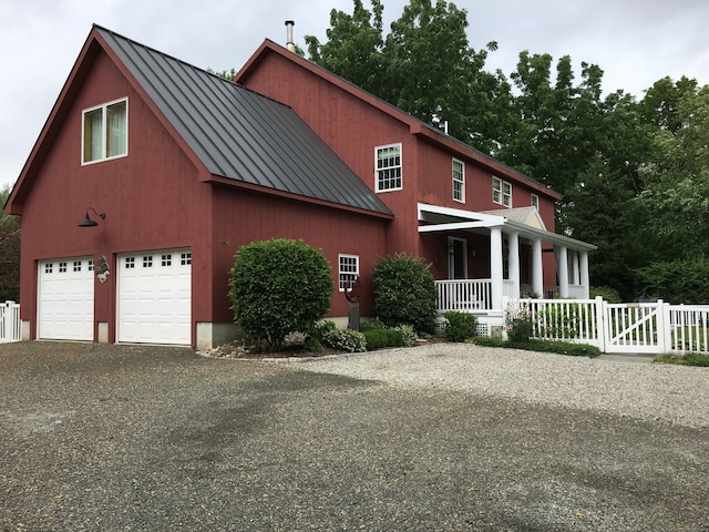 view of front of property with a porch and a garage