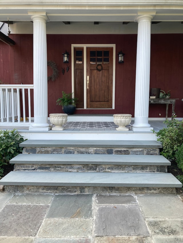 view of exterior entry featuring covered porch