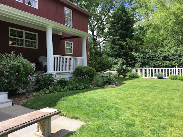 view of yard with covered porch