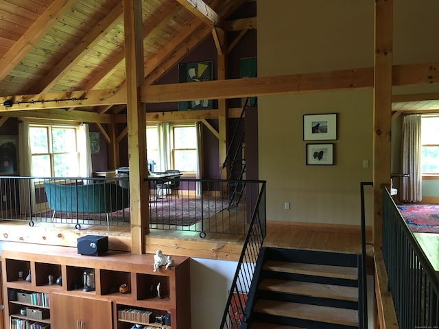 kitchen featuring hardwood / wood-style flooring, plenty of natural light, wood ceiling, and vaulted ceiling with beams