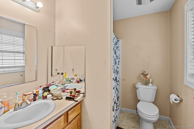 bathroom with a shower with shower curtain, tile patterned floors, vanity, and toilet