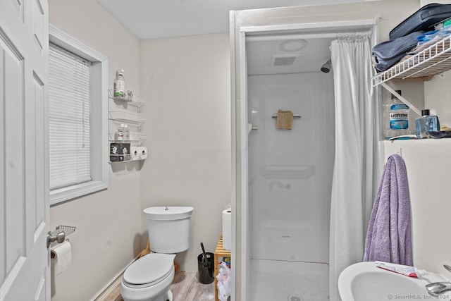 bathroom with sink, toilet, walk in shower, and hardwood / wood-style floors