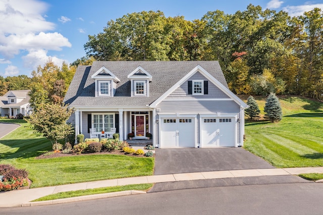 cape cod home featuring covered porch, a front lawn, and a garage