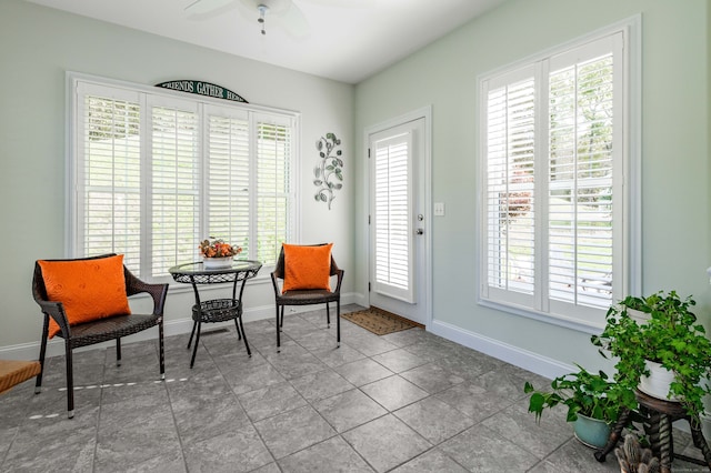 sitting room featuring light tile patterned floors and ceiling fan