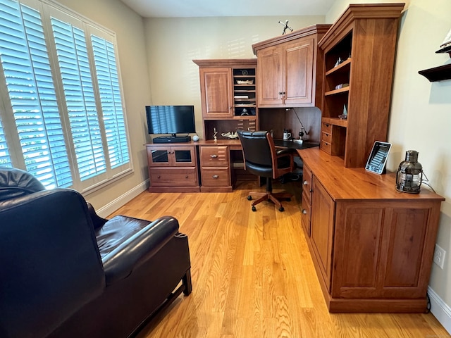 office area featuring built in desk and light wood-type flooring