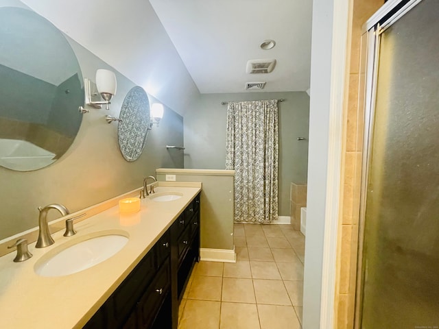 bathroom featuring vanity, a shower with door, and tile patterned floors