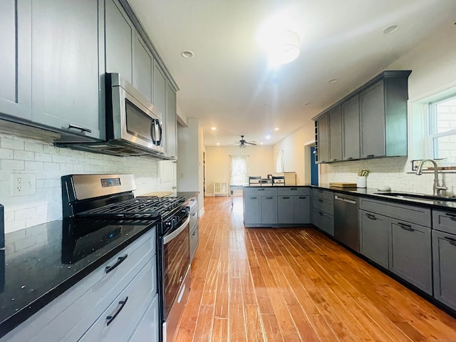 kitchen featuring appliances with stainless steel finishes, gray cabinets, and light hardwood / wood-style floors