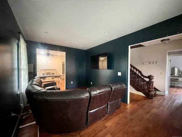 living room featuring hardwood / wood-style floors and ceiling fan