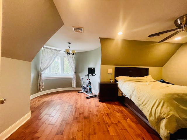 bedroom featuring ceiling fan, lofted ceiling, and hardwood / wood-style floors