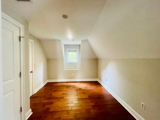 bonus room featuring lofted ceiling and dark hardwood / wood-style floors