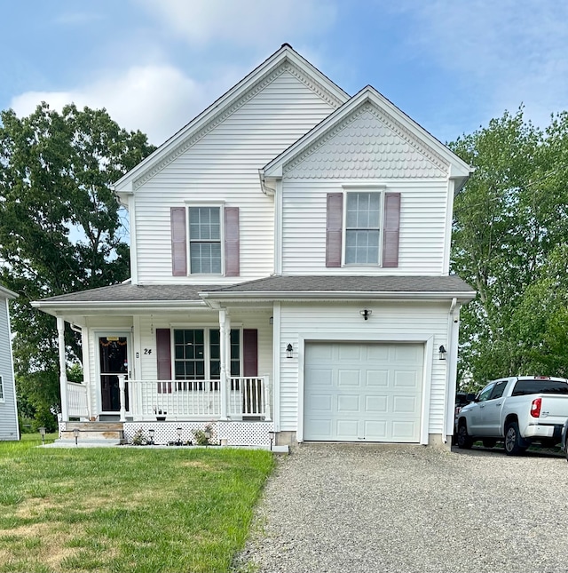 view of front of house featuring a front lawn, covered porch, and a garage