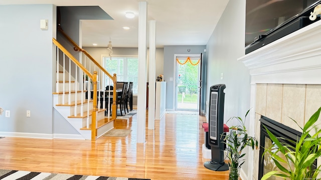 foyer entrance with a fireplace and hardwood / wood-style floors