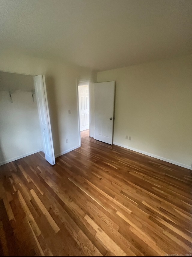 empty room featuring dark hardwood / wood-style flooring