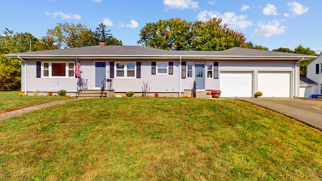 ranch-style home with a front yard and a garage