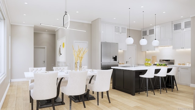 kitchen featuring stainless steel fridge, light hardwood / wood-style floors, white cabinets, crown molding, and a kitchen island with sink