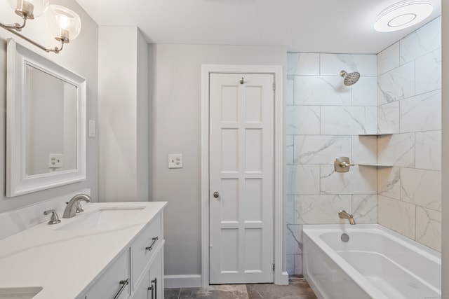 bathroom with tiled shower / bath combo and vanity