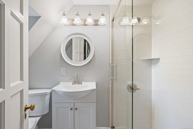 bathroom with vanity, lofted ceiling, toilet, and an enclosed shower