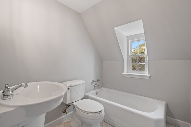 bathroom featuring toilet, a bathtub, sink, tile patterned floors, and vaulted ceiling