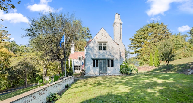 back of house with a lawn