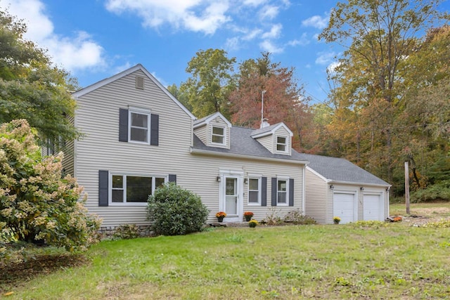 view of front of house featuring a garage and a front lawn