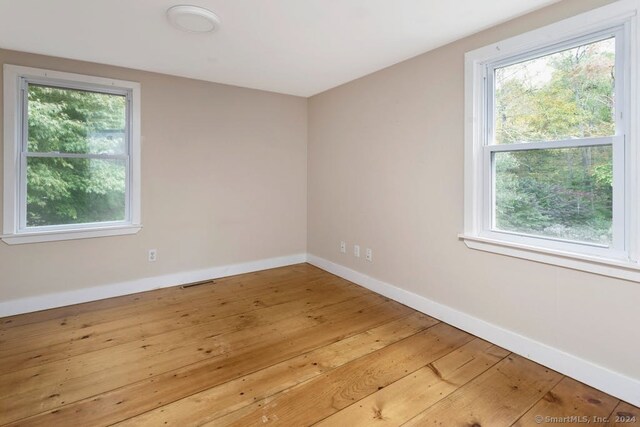 spare room with hardwood / wood-style floors