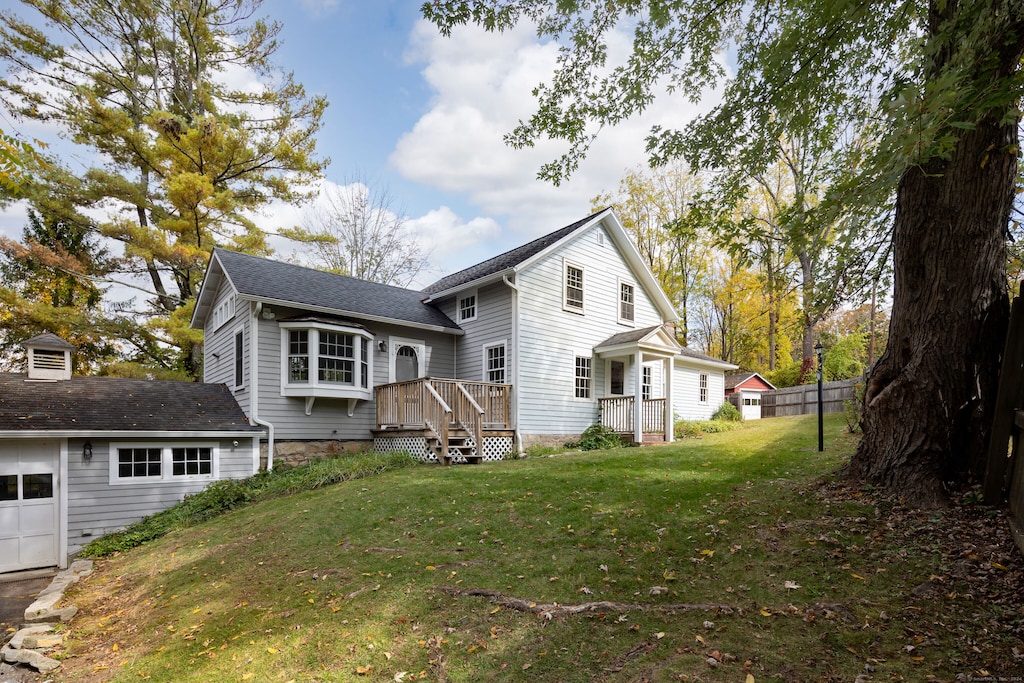 rear view of house featuring a yard