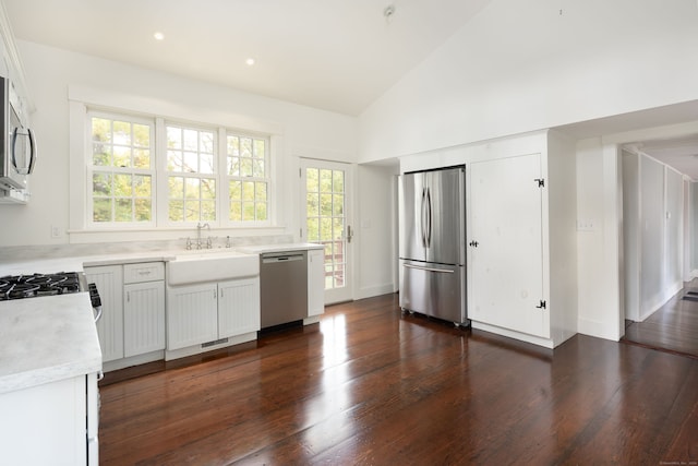 kitchen with white cabinets, appliances with stainless steel finishes, sink, and dark hardwood / wood-style flooring