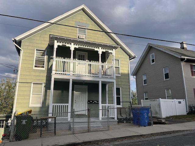 view of front of property featuring a balcony and a porch