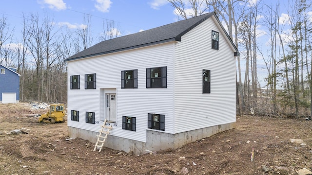 exterior space with roof with shingles