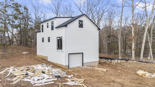 view of side of home featuring a garage