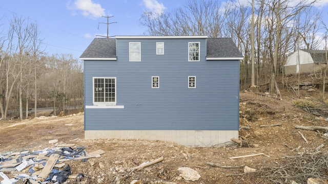 view of property exterior featuring roof with shingles