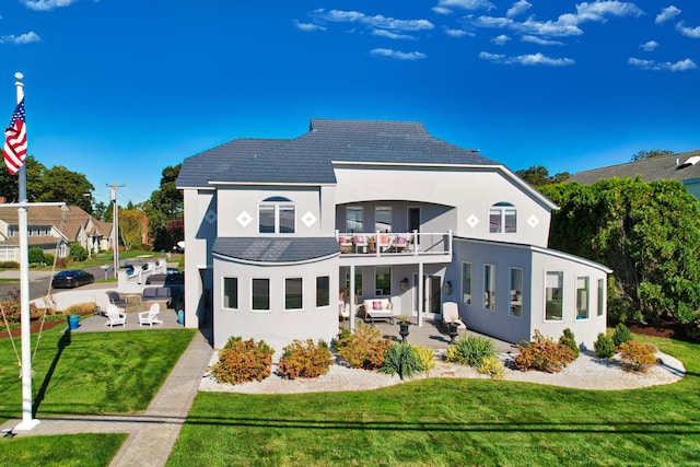 372 Maple Ave, Old Saybrook, CT 06475 - back of house featuring a balcony, a patio area, a lawn, and stucco siding
