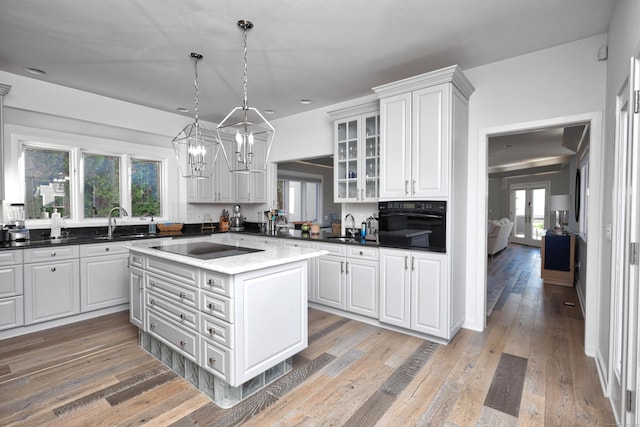 372 Maple Ave, Old Saybrook, CT 06475 - kitchen featuring black appliances, glass insert cabinets, white cabinets, and healthy amount of natural light
