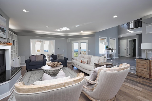 living room with french doors and dark wood-type flooring