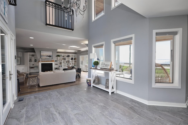 living room with built in shelves, french doors, and a chandelier