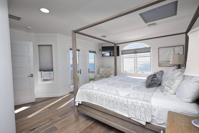 bedroom featuring crown molding and dark wood-type flooring