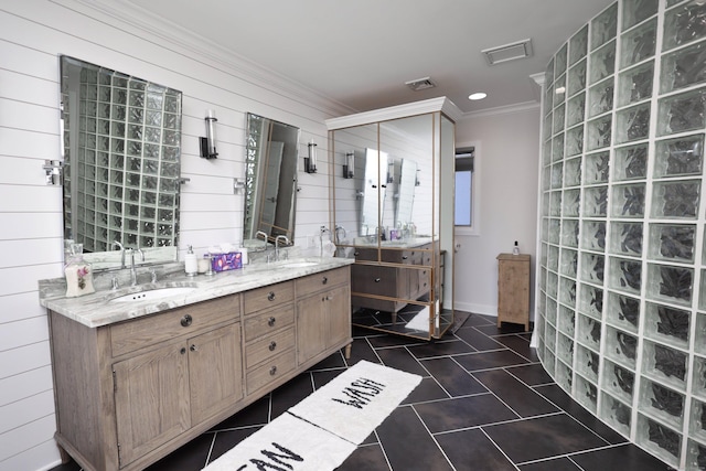 bathroom featuring wood walls, crown molding, and vanity