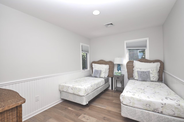 bedroom with dark hardwood / wood-style floors