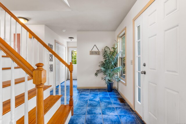 tiled entrance foyer featuring plenty of natural light