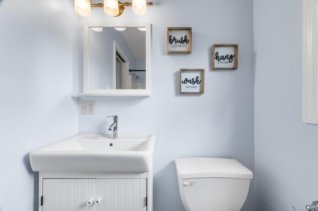 bathroom featuring vanity and toilet