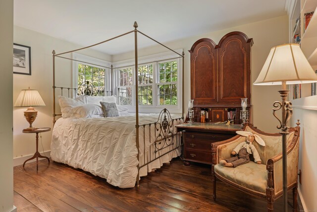 bedroom with dark hardwood / wood-style floors