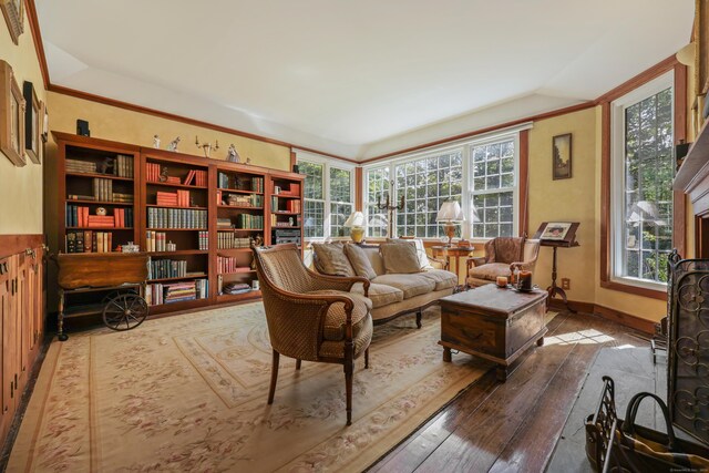 sitting room with a wealth of natural light and wood-type flooring