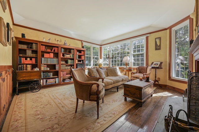 living room featuring lofted ceiling, wood-type flooring, and baseboards