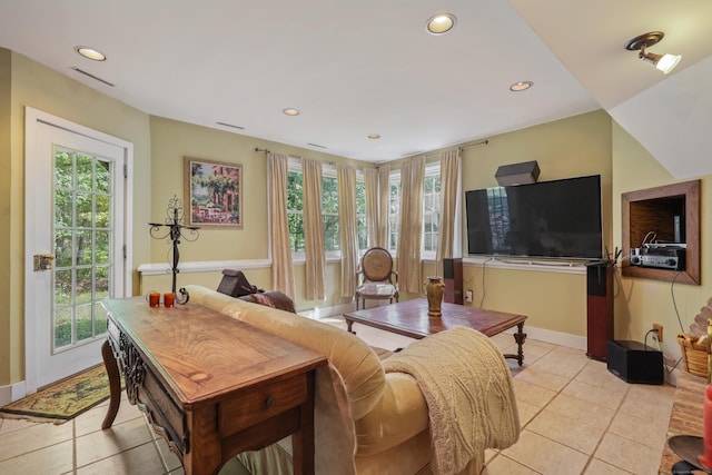 living area with light tile patterned floors, baseboards, and recessed lighting