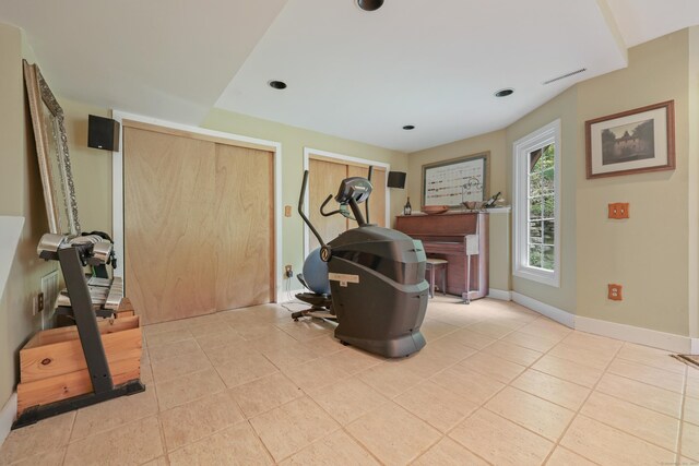 exercise area featuring light tile patterned floors