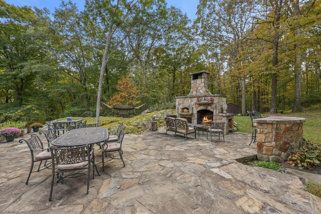 view of patio with an outdoor stone fireplace