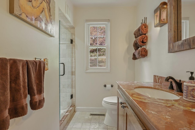 bathroom featuring visible vents, toilet, a shower stall, vanity, and baseboards