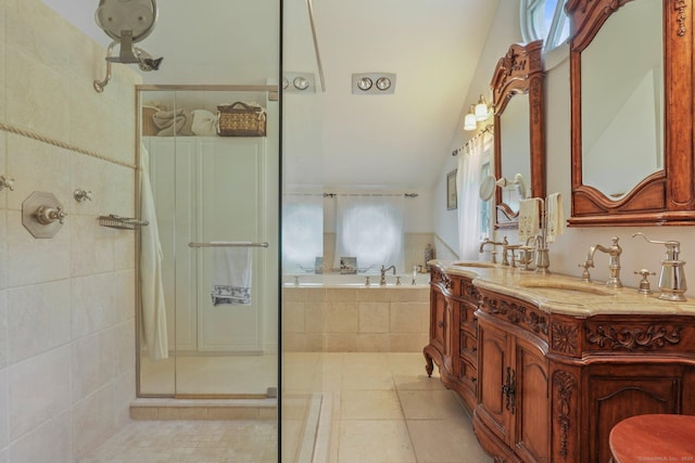 full bath with double vanity, a stall shower, tile patterned floors, a garden tub, and a sink