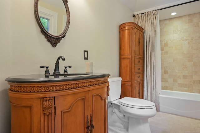 bathroom featuring vanity, shower / bath combination with curtain, and toilet