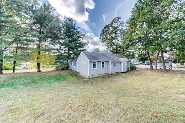 view of side of property with a lawn